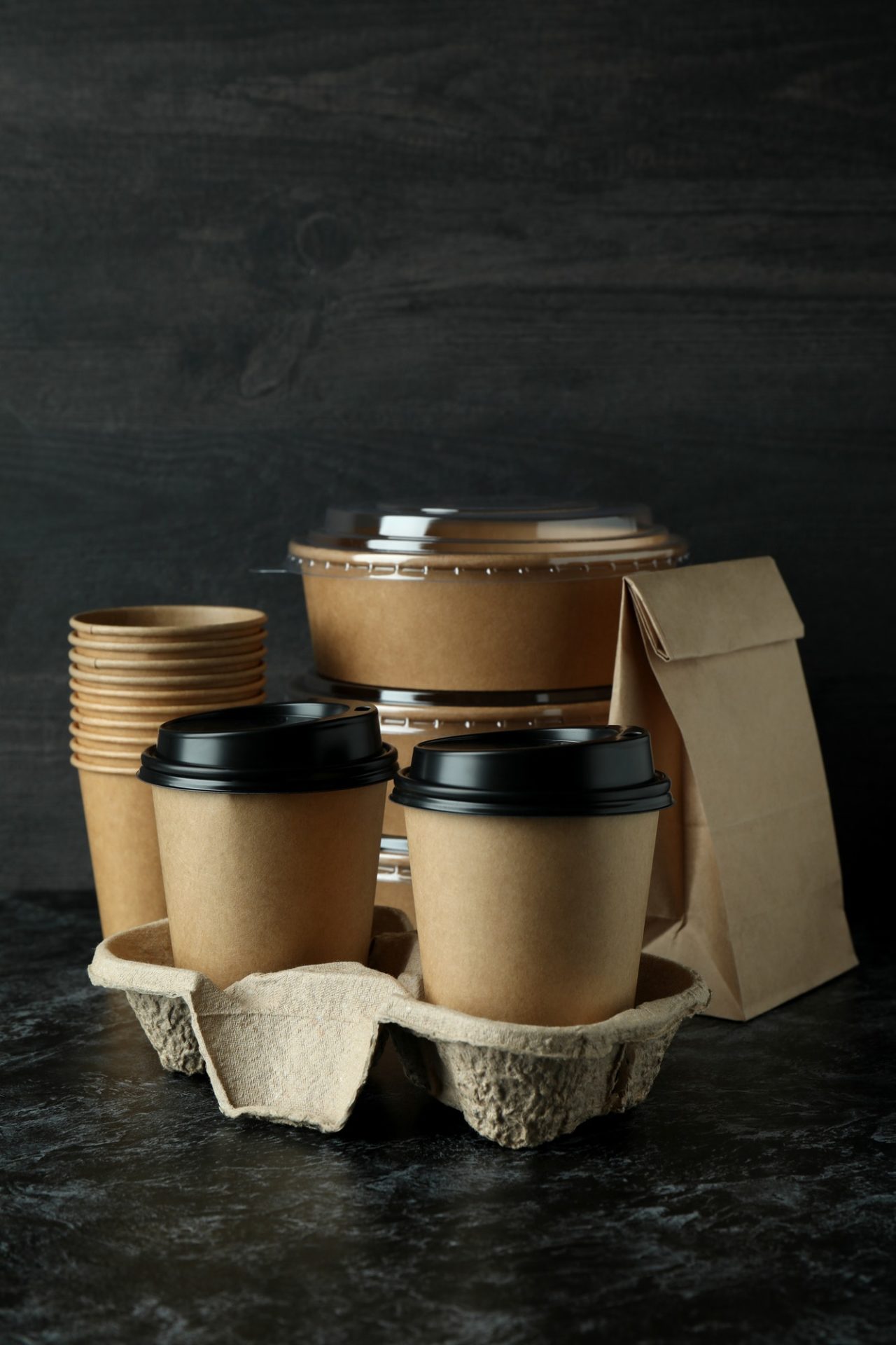 Delivery containers for takeaway food on a dark smoky table